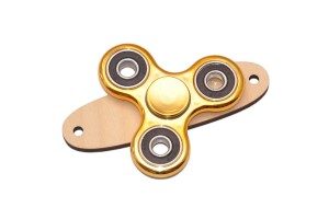 Złoty spinner do tablicy sensorycznej na podstawce.  